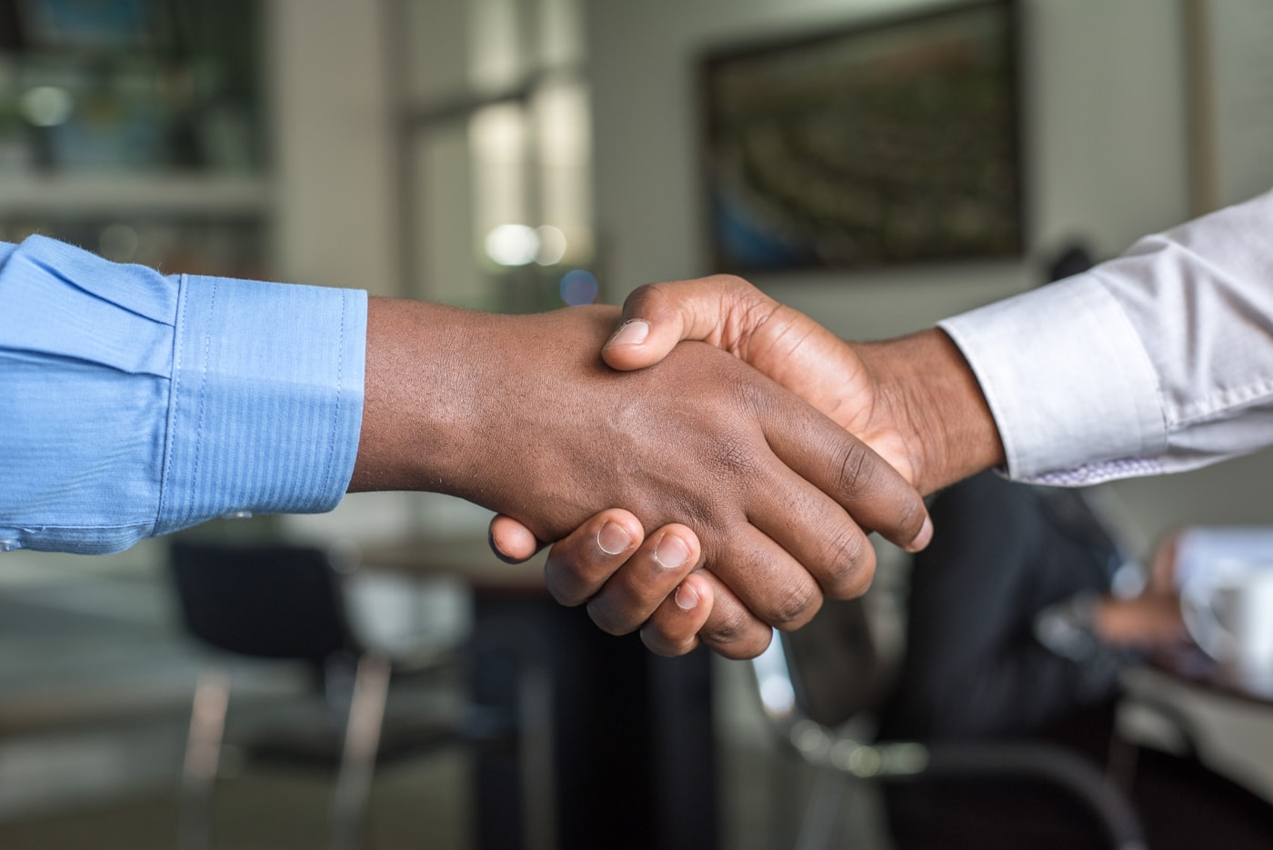 Two hands joining, partnership with Terra Humana